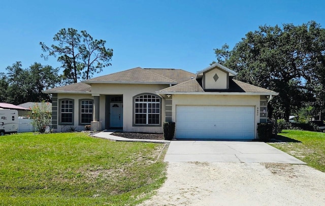 single story home featuring concrete driveway, stucco siding, a front yard, and a garage