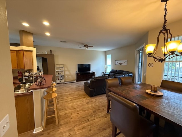 dining area featuring a chandelier, light wood finished floors, a ceiling fan, and recessed lighting