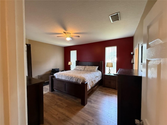 bedroom with wood finished floors and a ceiling fan