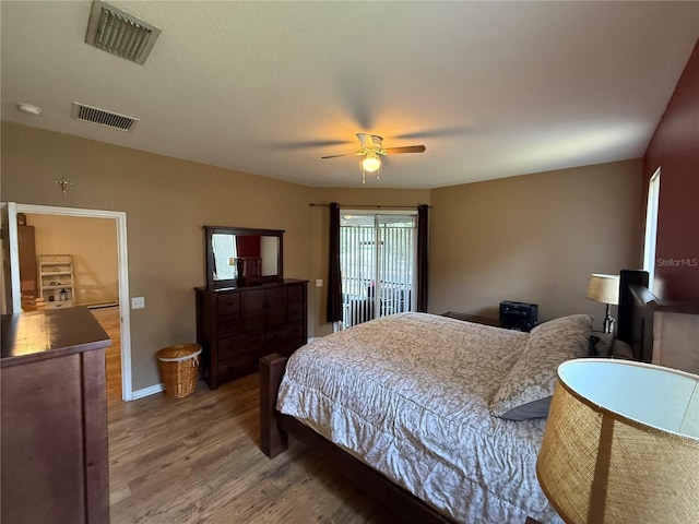 bedroom with light wood-style floors, ceiling fan, and baseboards
