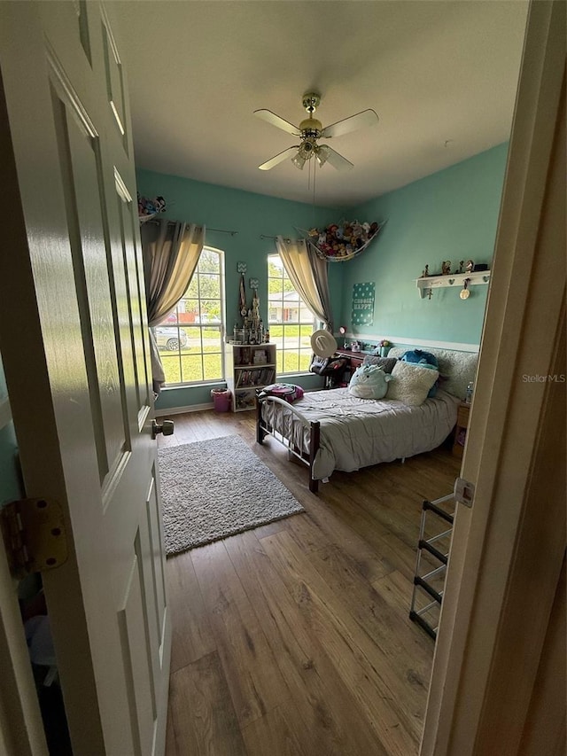 bedroom featuring wood finished floors and a ceiling fan