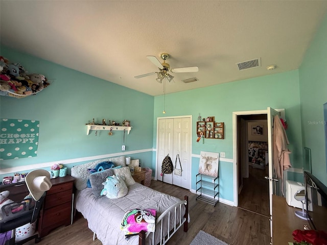 bedroom with wood finished floors, a closet, and a ceiling fan