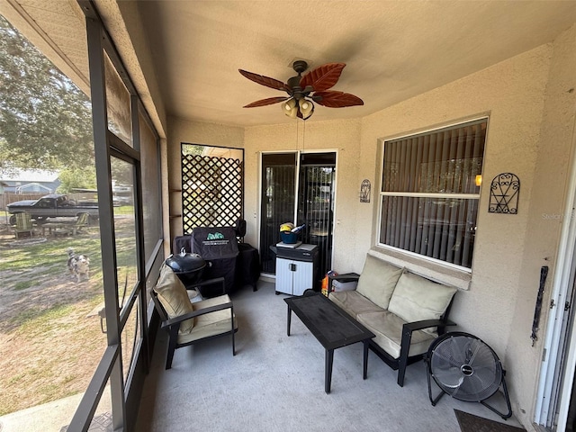 sunroom / solarium featuring ceiling fan