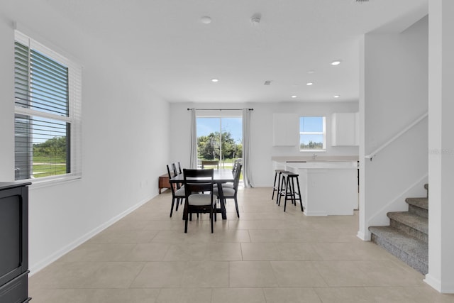 dining area with stairway, recessed lighting, light tile patterned floors, and baseboards