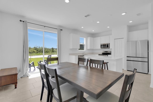 dining area with recessed lighting and light tile patterned floors