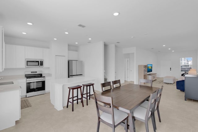 dining room featuring recessed lighting and stairway