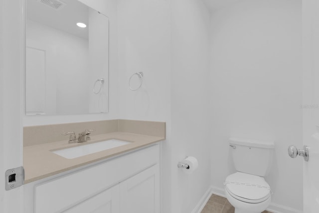 bathroom featuring baseboards, toilet, vanity, and tile patterned floors