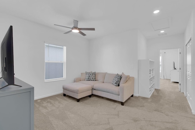 living area with ceiling fan, light carpet, recessed lighting, baseboards, and attic access