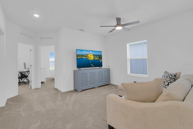 living area with a ceiling fan, baseboards, light carpet, and recessed lighting
