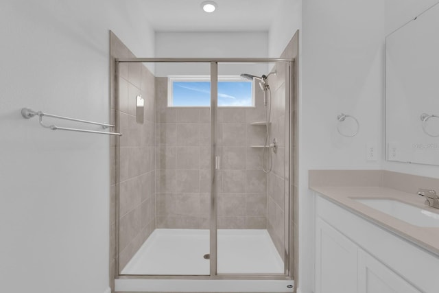 full bathroom with a stall shower and vanity