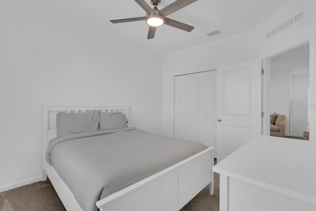 bedroom with dark colored carpet, a closet, a ceiling fan, and baseboards
