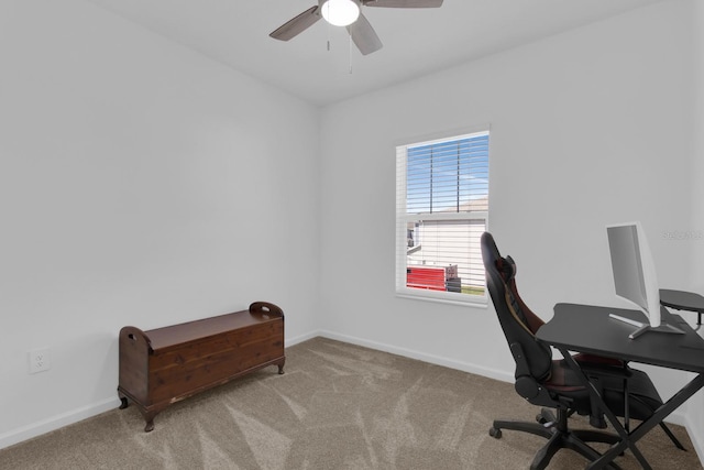carpeted home office featuring ceiling fan and baseboards