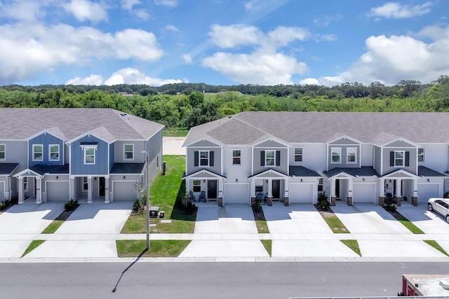 townhome / multi-family property featuring driveway and a garage