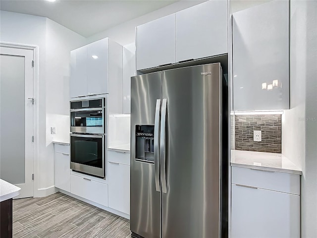 kitchen with appliances with stainless steel finishes and modern cabinets