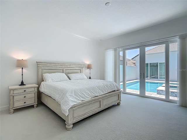 bedroom featuring access to exterior and light colored carpet
