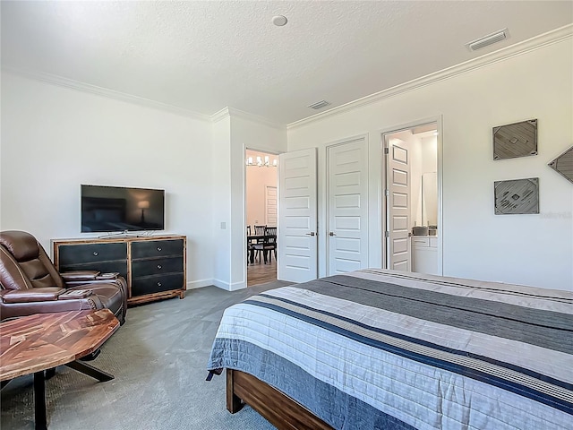 carpeted bedroom featuring crown molding, a chandelier, a textured ceiling, and ensuite bath
