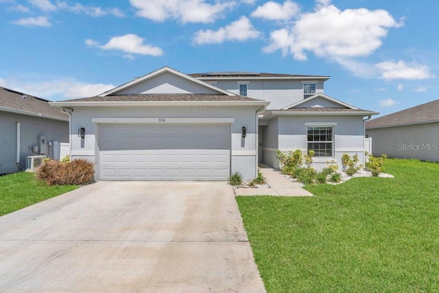 374 Pine Tree Bridge Trl, Saint Cloud, FL 34772 - view of front of home featuring stucco siding, concrete driveway, an attached garage, a front lawn, and solar panels