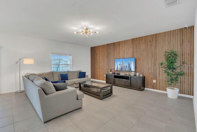 374 Pine Tree Bridge Trl, Saint Cloud, FL 34772 - living room with wooden walls, an accent wall, a chandelier, baseboards, and light tile patterned floors