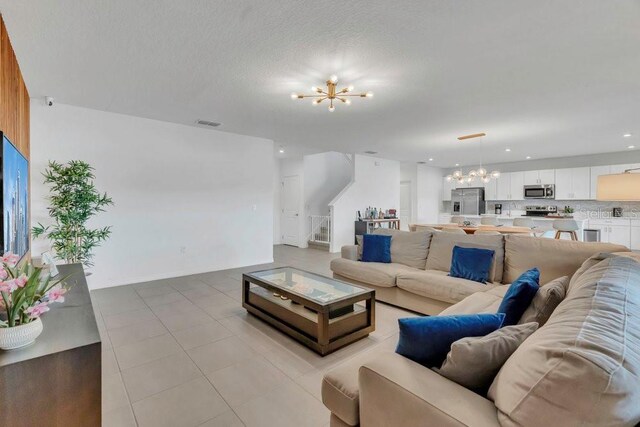 374 Pine Tree Bridge Trl, Saint Cloud, FL 34772 - living area featuring a chandelier, recessed lighting, light tile patterned floors, and stairs