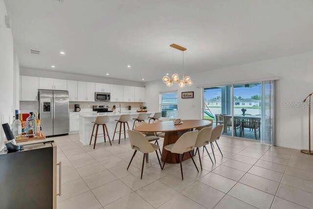 374 Pine Tree Bridge Trl, Saint Cloud, FL 34772 - dining room with light tile patterned floors, recessed lighting, and a chandelier