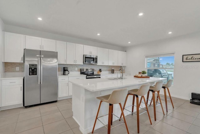 374 Pine Tree Bridge Trl, Saint Cloud, FL 34772 - kitchen with appliances with stainless steel finishes, a sink, backsplash, white cabinets, and recessed lighting