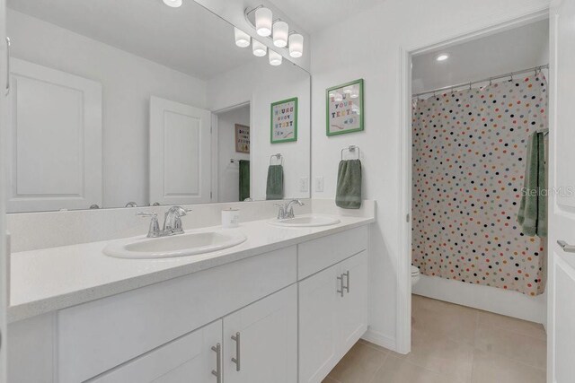 374 Pine Tree Bridge Trl, Saint Cloud, FL 34772 - full bathroom featuring double vanity, tile patterned flooring, toilet, and a shower with curtain