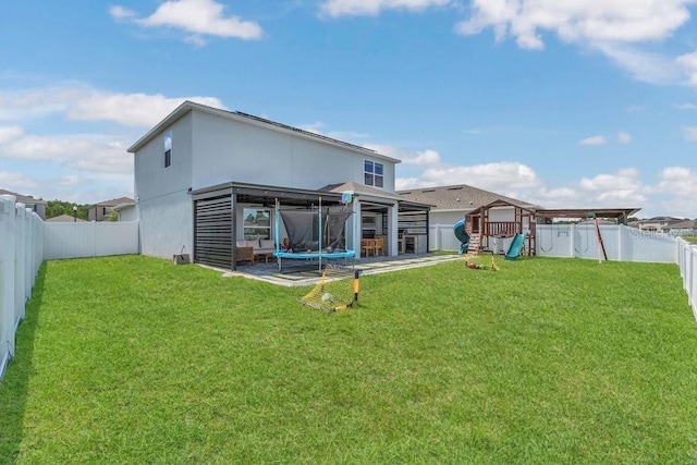 374 Pine Tree Bridge Trl, Saint Cloud, FL 34772 - back of property with a playground and stucco siding