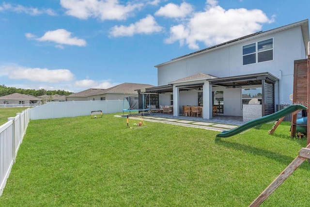 374 Pine Tree Bridge Trl, Saint Cloud, FL 34772 - rear view of property featuring a trampoline, stucco siding, a patio, and a ceiling fan