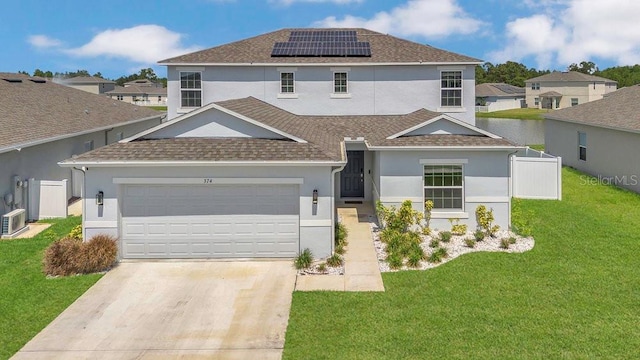 374 Pine Tree Bridge Trl, Saint Cloud, FL 34772 - view of front of house with solar panels, a shingled roof, concrete driveway, stucco siding, and a garage