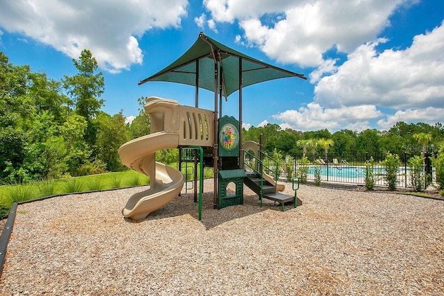 374 Pine Tree Bridge Trl, Saint Cloud, FL 34772 - community jungle gym with fence and a community pool