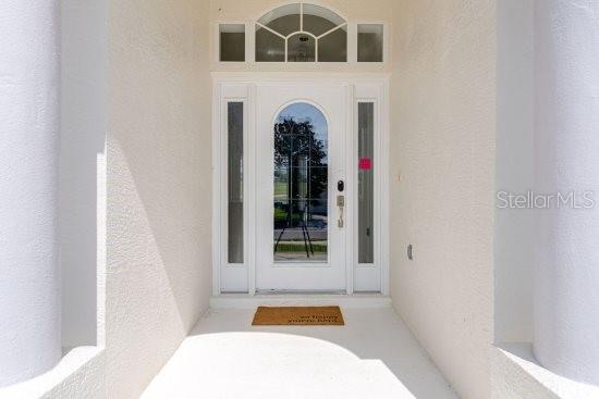 property entrance with stucco siding