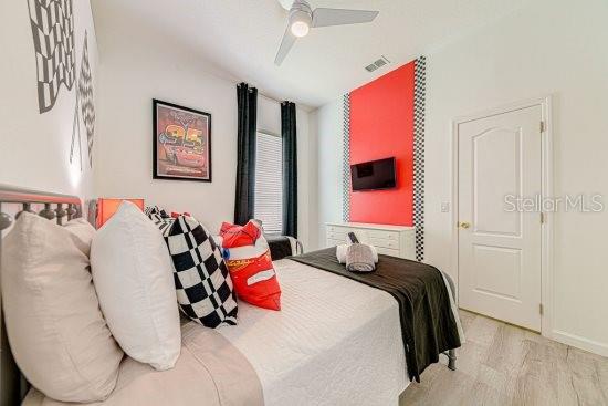 bedroom featuring wood finished floors and a ceiling fan