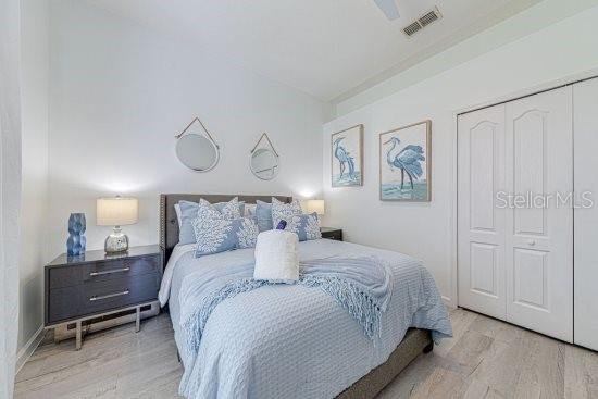 bedroom featuring wood finished floors, a closet, and a ceiling fan