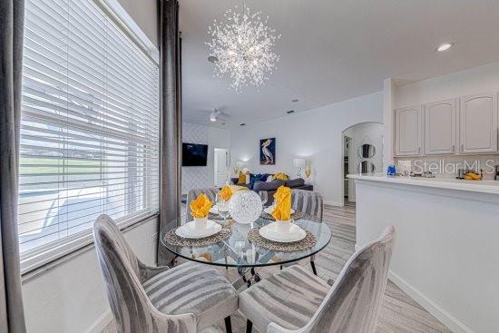 dining area featuring arched walkways and baseboards