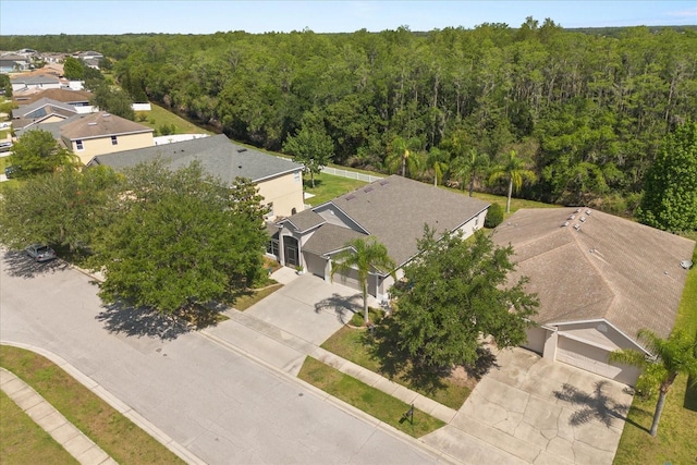 aerial view of residential area featuring a heavily wooded area