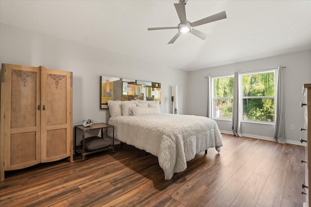 bedroom featuring dark wood-type flooring, a ceiling fan, and baseboards