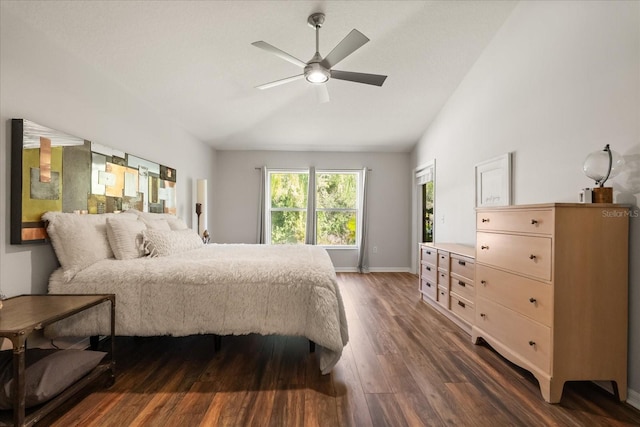 bedroom featuring dark wood-style floors, lofted ceiling, baseboards, and ceiling fan