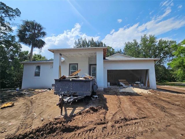 1400 Conrad Dr, New Smyrna Beach, FL 32168 - view of front facade featuring a garage, driveway, and stucco siding