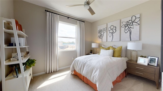 bedroom with light colored carpet, baseboards, and ceiling fan