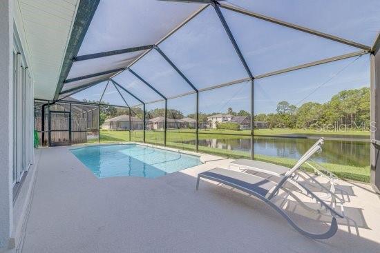 2908 Sunset Lakes Blvd, Kissimmee, FL 34747 - swimming pool with a water view, a patio, and a lanai