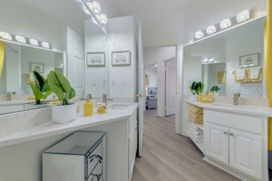 2908 Sunset Lakes Blvd, Kissimmee, FL 34747 - bathroom with wood finished floors and vanity