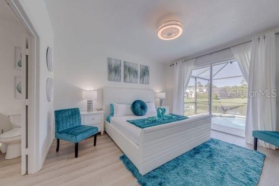 2908 Sunset Lakes Blvd, Kissimmee, FL 34747 - bedroom featuring access to exterior and light wood finished floors