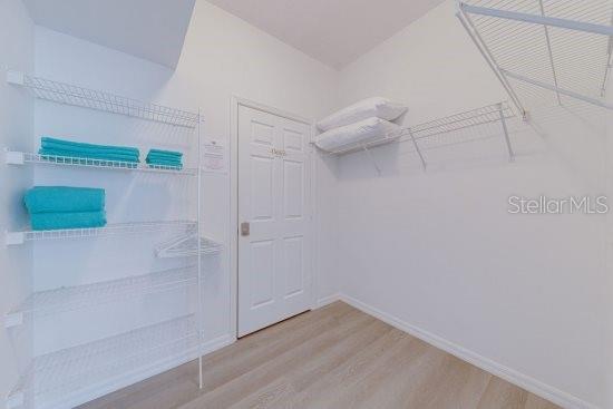 2908 Sunset Lakes Blvd, Kissimmee, FL 34747 - walk in closet featuring wood finished floors