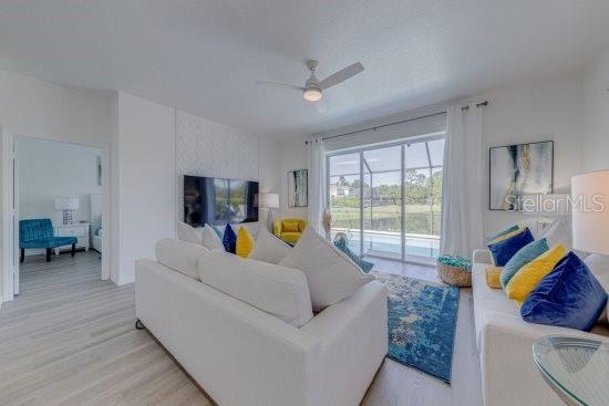 2908 Sunset Lakes Blvd, Kissimmee, FL 34747 - living room featuring light wood-style floors and ceiling fan