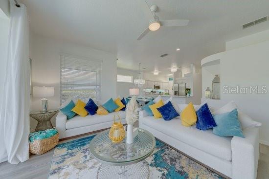 2908 Sunset Lakes Blvd, Kissimmee, FL 34747 - living area featuring ceiling fan and wood finished floors