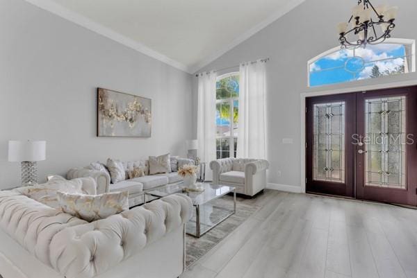 721 Hardwood Cir, Orlando, FL 32828 - foyer entrance with lofted ceiling, a chandelier, french doors, ornamental molding, and wood finished floors