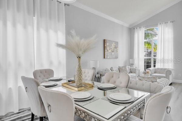 721 Hardwood Cir, Orlando, FL 32828 - dining space with crown molding, lofted ceiling, baseboards, and wood finished floors
