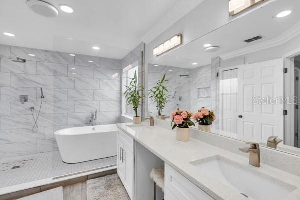 721 Hardwood Cir, Orlando, FL 32828 - bathroom with a tile shower, double vanity, a freestanding tub, recessed lighting, and ornamental molding