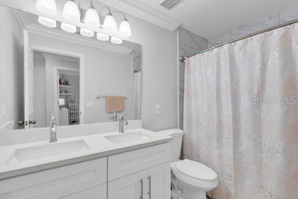 721 Hardwood Cir, Orlando, FL 32828 - full bath featuring toilet, double vanity, ornamental molding, and a shower with shower curtain