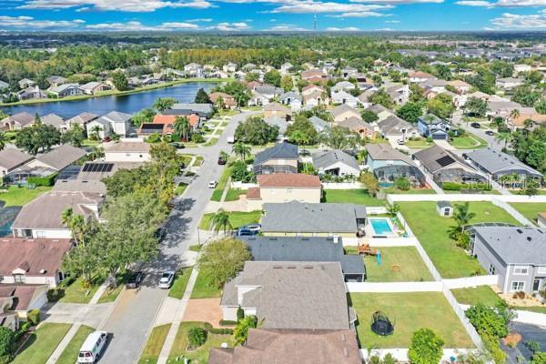 721 Hardwood Cir, Orlando, FL 32828 - aerial view of property and surrounding area with nearby suburban area and a large body of water